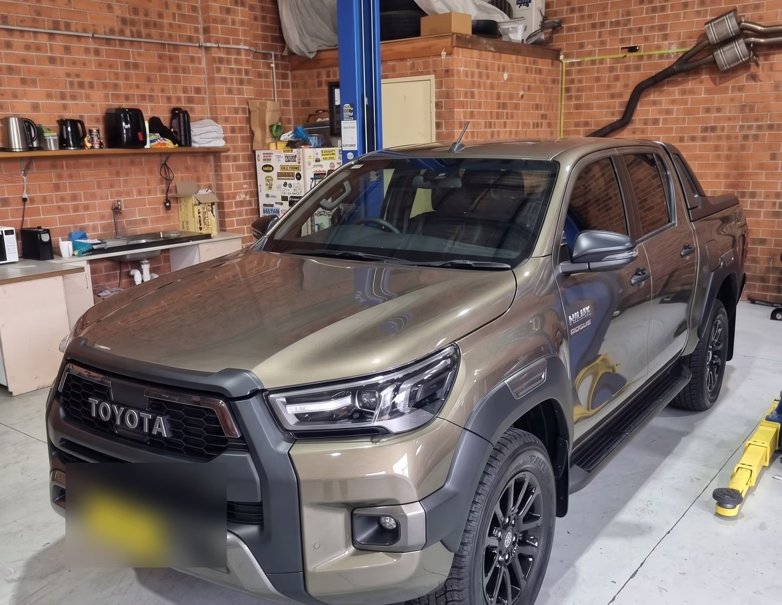 A customer's vehicle up on the hoist inside the Central East Mechanical workshop in Dapto