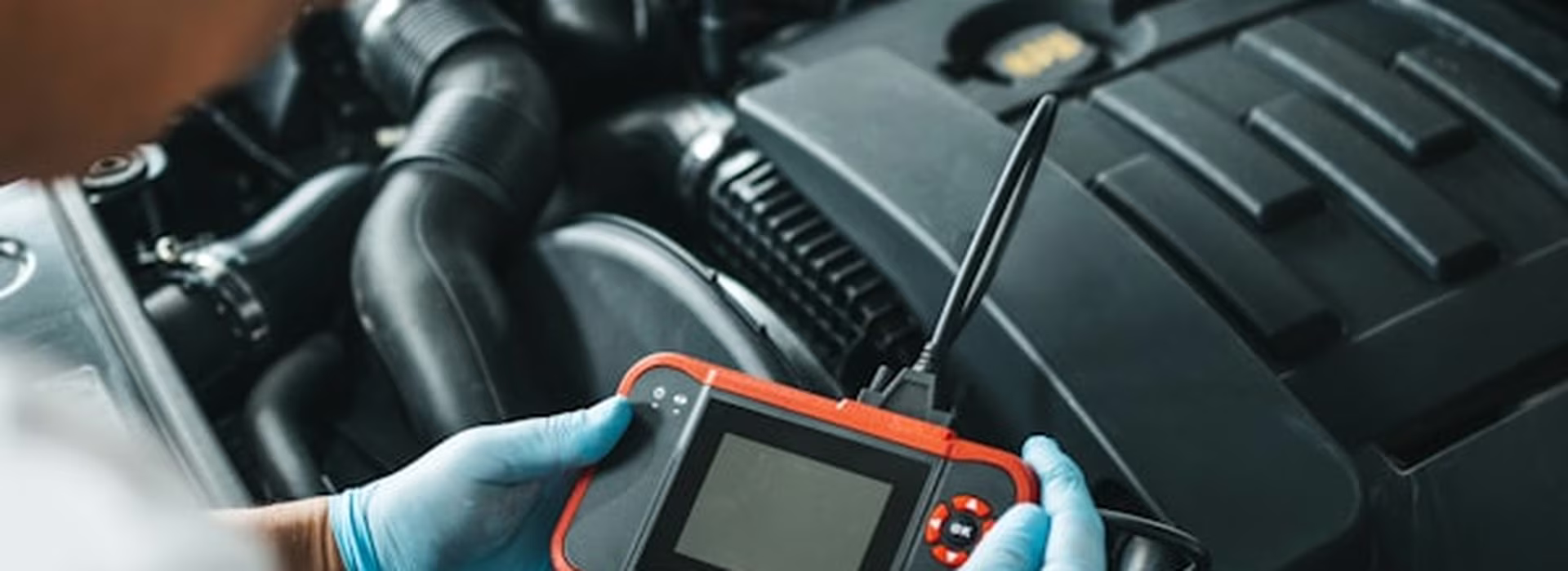 Diagnostic scan tool connected to a vehicle reading engine fault codes at Central East Mechanical in Dapto