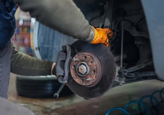 Worn brake pad and disc rotor being replaced on a car at Central East Mechanical in Dapto